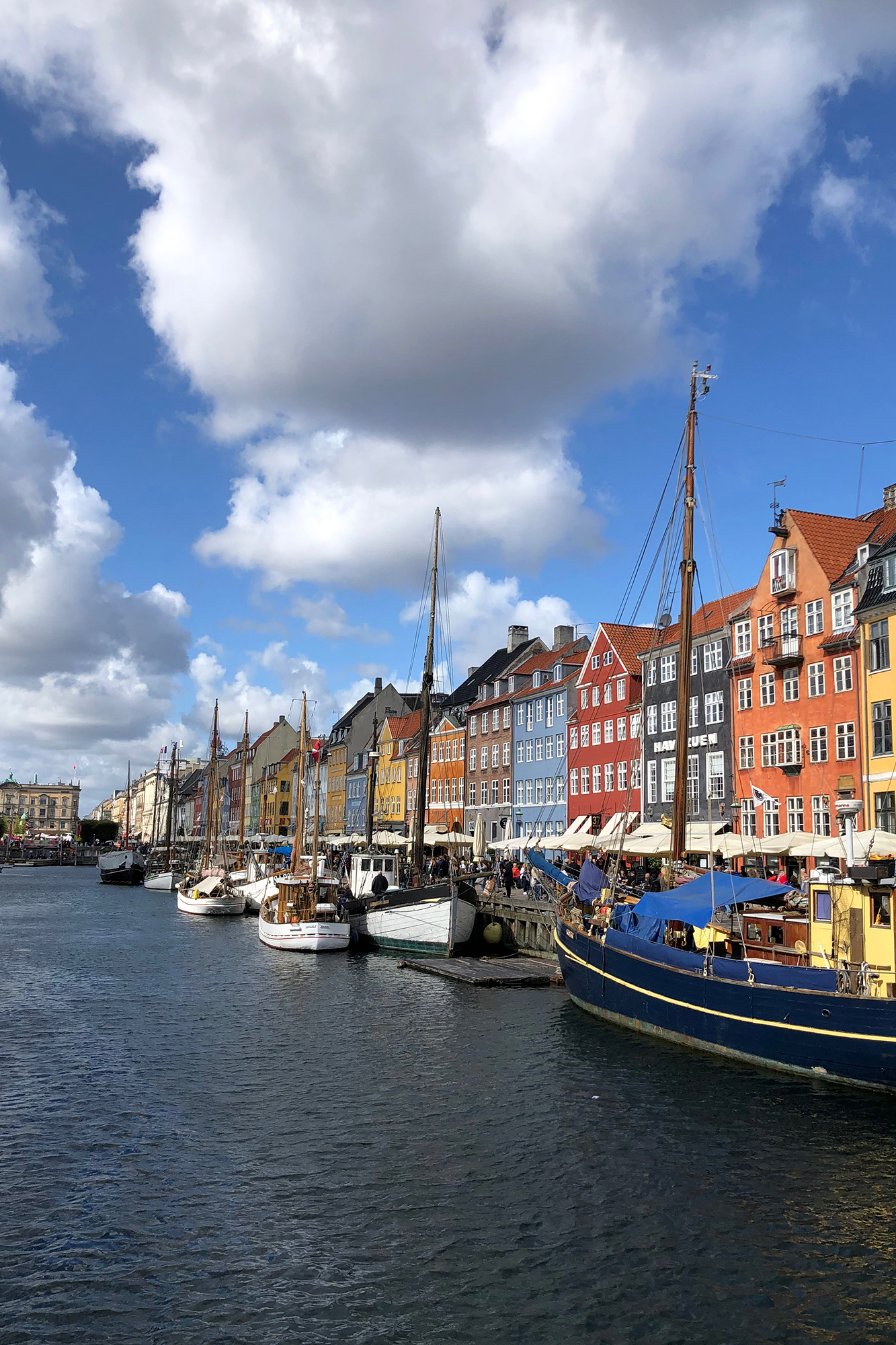 sailboats-moored-river-by-buildings-city-against-sky