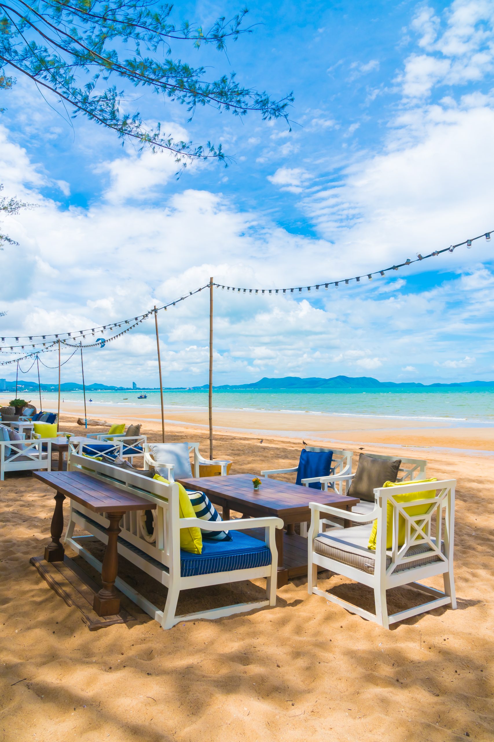 Chair and table dinning on the beach and sea with blue sky background